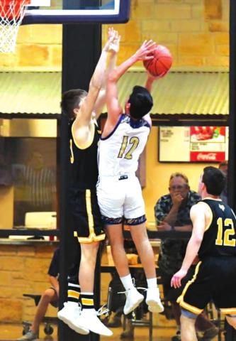 San Saba High School boys varsity basketball junior forward Noah Martinez (12) puts up a contested shot on Friday, February 11th, during the Dillos’ 45-34 victory at home vs. district rival Goldthwaite High School. (Photo by Rita Boultinghouse)