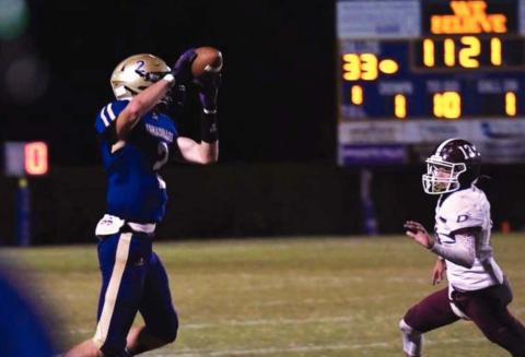 Logan Glover makes a catch on a school record 98 yard score. (Photo by Rita Boultinghouse)