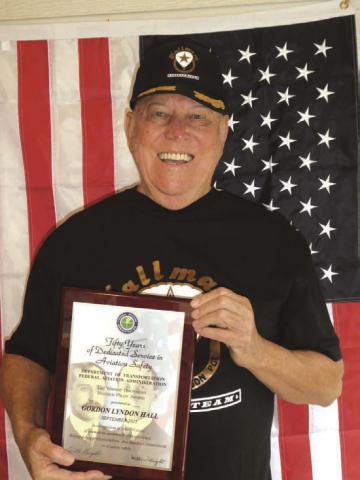 Gordon Hall proudly holding his “Wright Brothers Master Pilot Award”