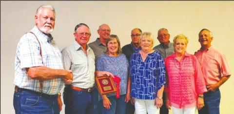 Standing in the front row (L to R) are C.K. Stevenson, San Saba Soil and Water Conservation District (SWCD) Board Chairman; Joe Ellis, Jr. and his wife, Kathy; Sylvia Ellis Taylor, Cheryl Ellis Hinyard and husband, Mike. Forming the back row (L to R) include: Neal Alexander, Board member; Pat Pool, Board member; and Johnie Reeves, Board Secretary. Not pictured is Jackie Brister, Board member.