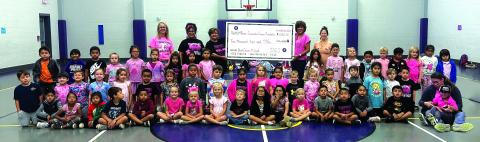 SSES Elementary students with their teachers and the Never Surrender Cancer Foundation representatives. Adults in the back: Mrs. Oliver, Mrs. Ceci, Donna Shahan, Dora Miller, and Mrs. Bessett. Courtesy of Dani Gilcrease