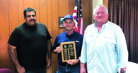 Paul Stewart, Street Department employee, is shown holding the Employee of the Month plaque. Pictured to his right is Street Department Supervisor Luis Rios and to his left is Alderman Shawn Oliver. Photo by Scott Glaze