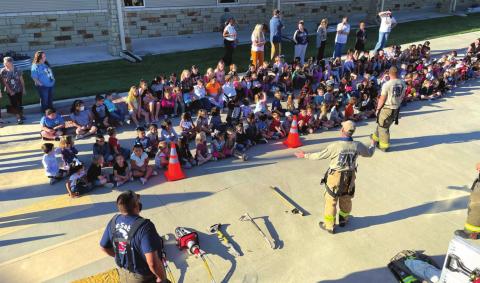 Volunteer firefighters shown in foreground are L-R: Juan Montoya, Jack Blossman, and Michael Ward.