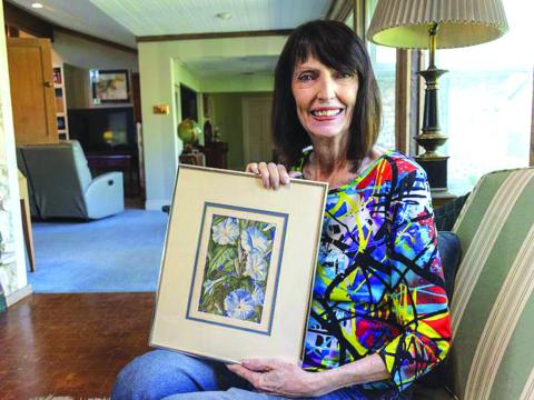 Jane Felts Mauldin is holding a painting of flowers she created in February of 1954 when she was 13 years old. Her father kept it for years without her knowing. Tyler Johnson | Herald-Zeitung