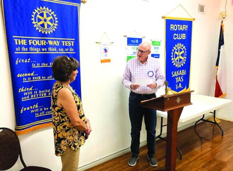 Sergeant of Arms Tom Griess inducting Dora Cisneros Miller back to Rotary as a returning member