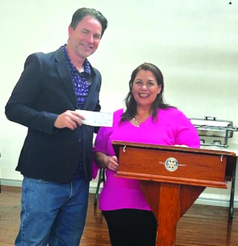Marcus Wood presents Angie Chandler, Executive Director of The Dove Project in San Saba, with the $1,000 donation on behalf of the Rotary Club. Courtesy of Beth Griess