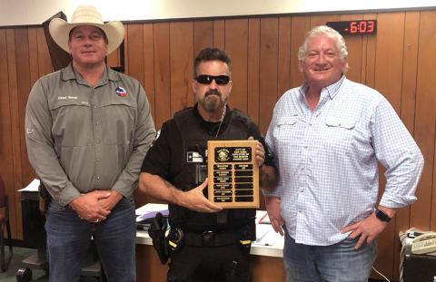 June Employee of the Month Left to right: Police Chief John Bauer; Police Officer Eric Batchelor, June Employee of the Month; and Alderman Shawn Oliver