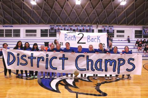 The Richland Springs High School girls varsity basketball team eagerly and happily pose with their coaches and the banner announcing their newly acquired status of Bi-District Champs. After winning the District Championship on Monday, February 14th, the Lady Coyotes went on to win the Bi-District title after beating Gustine’s Lady Tigers, 79-24. (Photo by Pam Starr)