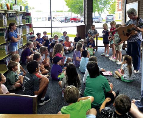 Ms. Shelia Meador leading the elementary school kids with songs, reading, and fun with Teddy the puppet! Courtesy of Meredith Houck 