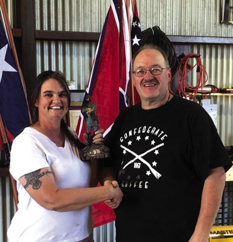SCV Camp Commander Michael Oliver (R) presents a firstplace trophy, a statue of Stonewall Jackson, to first place winner Cheryl Ayers of the black powder turkey shoot held on Saturday, May 3rd. Cheryl is the wife of the SCV camp commander of the William County Grays No. 502. She just happened to be an expert seamstress who creates period uniforms and ladies dresses. Courtesy of Ross Cox, Sr.