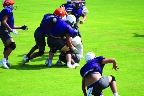 Here is an action shot from last Saturday’s Purple and Gold Scrimmage. The purple jerseys are Varsity and white jerseys are JV. Photo courtesy of Jake Lackey