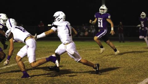 Glover (#11) makes a block for Tharp (#1) as he runs to the end zone. Courtesy of Kayti Lackey