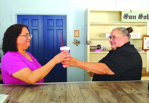 San Saba Dairy Queen Manager Pearl Moreno presents a Blizzard Treat to Yvonne Contreras, San Saba News &amp; Star Advertising Director, after the traditional 'turn the Blizzard upside down.'