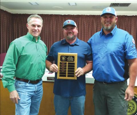 Employee of the Month Chris Stewart, Parks Department employee, displays an Employee of the Month plaque with his name engraved for selection as the City's Employee of the Month for April. He also received a gift certificate to a local restaurant. At Chris' right is Alderman Marcus Amthor, and on his left is Eugene Bessent, Parks Department Supervisor, taking part in the presentation. (Staff Photo)