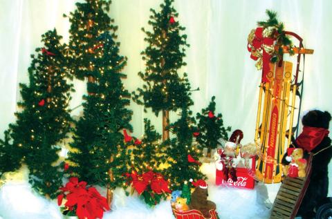 Christmas tree forest depicting stuffed animals engaged in winter sports