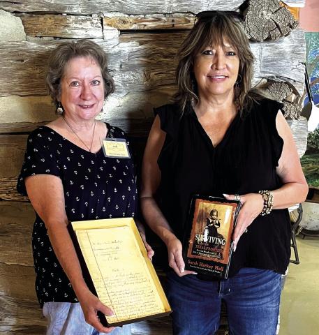 Rosemary Cox, Museum docent, accepts Sarah Harkey Hall’s original handwritten manuscript of “Surviving on the Texas Frontier – The Journal of an Orphan Girl in San Saba County” from Sarah’s great-great-granddaughter, Lisa Holloway. Photo courtesy of Cindy Sloan