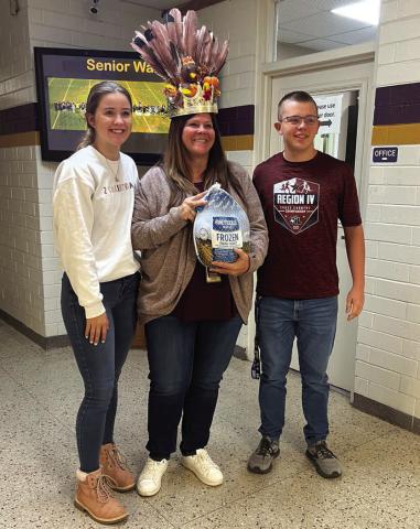 Pictured above: The winner of the High School campus 'Turkey of the Year' Food Drive was Elizabeth Chambers. The turkey and crown were presented by Madison Shahan and John Ham. The crown was made by Sabrina Dozier. - Photo by Shara Wright