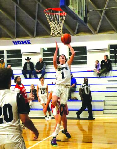 #1 Hutton Rogers has his eyes on the prize as he leaps for the basket.