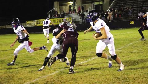 #2 Keston Lusty gets some yardage with the help from teammates.