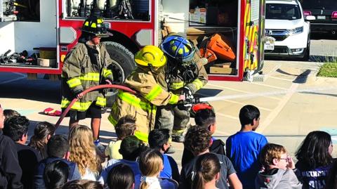 Fire Day at SSISD - Fourth graders Corbin Knight and Luis Lopez spraying the fire hose Photo submitted by Teresa Glover, SSISD