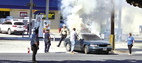 You can see people trying to put our the fire even before the car was pushed away from the pumps. Courtesy of Cindy Prater