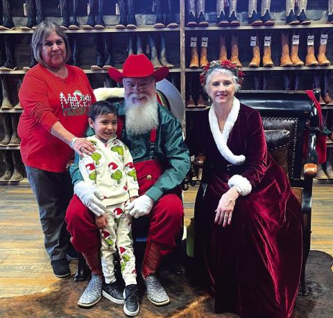 Sylvia Gomez and her grandson, Grayson Velez, age 5, visited with the Clauses during the 86th Anniversary &amp; Christmas Celebration at Harry’s Boot Store, Saturday, December 20th in downtown San Saba. Photo by Kellie Thompson