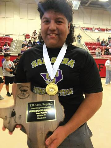 San Saba High School’s Christian Ramirez dominated the regional powerlifting meet last Saturday and will be headed to the state competition March 15th. Ramirez proudly shows off his gold medal along with his “outstanding squatter” plaque. Ramirez broke the regional squat record (740 pounds) and total weight lifted (1,655 pounds). Photo courtesy of SS Coaches