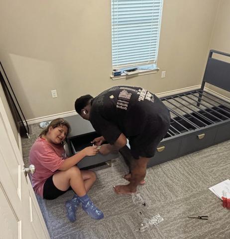 Phoebe and Erick assembling beds