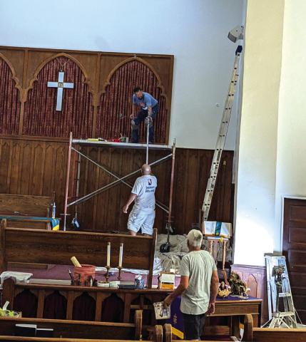 Mike Flores on the ground looking up at his employees as they are working hard on the First Methodist Church sanctuary. Photo courtesy of Jeffrey Carlson