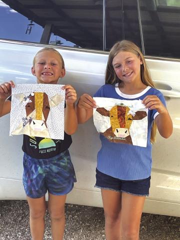 Alleigh Couch and Randa Couch showing the results of the summer quilt project. Photo by their grandmother, Kathy Davee
