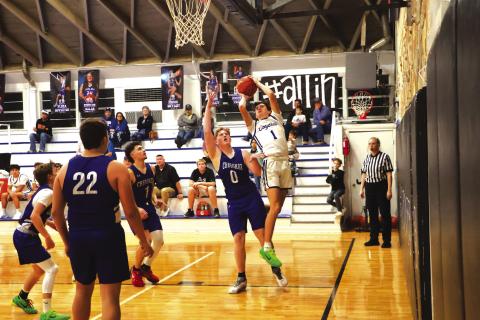 # 1 Hutton Rogers stretching in whatever way is necessary as he goes up for 2 points in last week’s win over Cherokee. Courtesy of Pam Starr