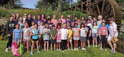 Kampers from the 2025 Kids’ Nature Kamp posed for a group photo by the Water Wheel before they went to the next station. Photo by Djuana Payton